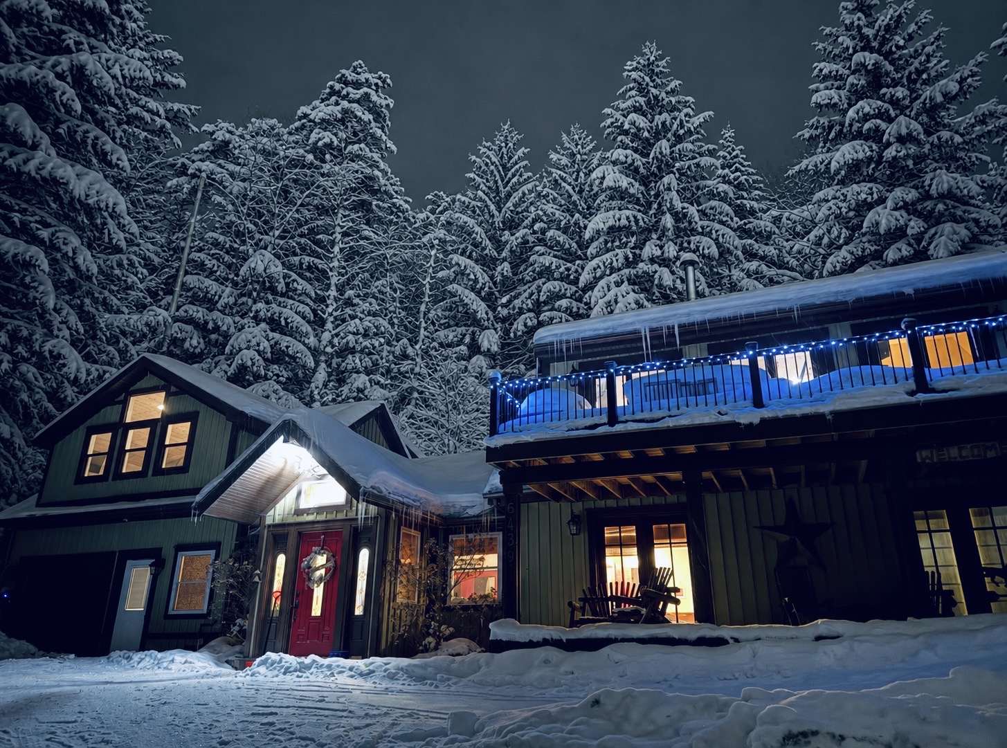 Bent Pole Lodge glowing beneath a forest of snow-covered trees